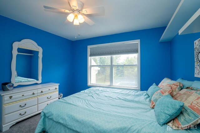 carpeted bedroom with ceiling fan