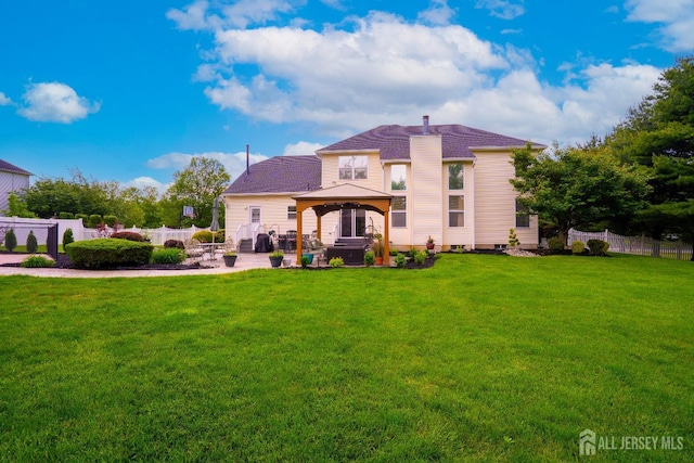back of property featuring a gazebo and a patio area