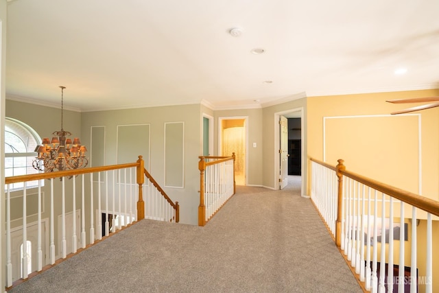 hall with a chandelier, an upstairs landing, carpet flooring, crown molding, and recessed lighting