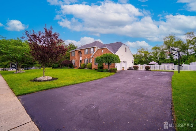 view of front of property featuring driveway, a garage, and brick siding