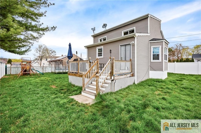 back of property featuring a playground and a wooden deck