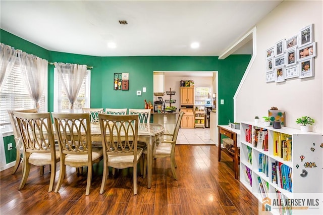 dining area featuring hardwood / wood-style flooring and recessed lighting