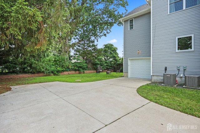 22 Sadowski Dr, Old Bridge, NJ 08857 - view of patio / terrace featuring a garage and driveway