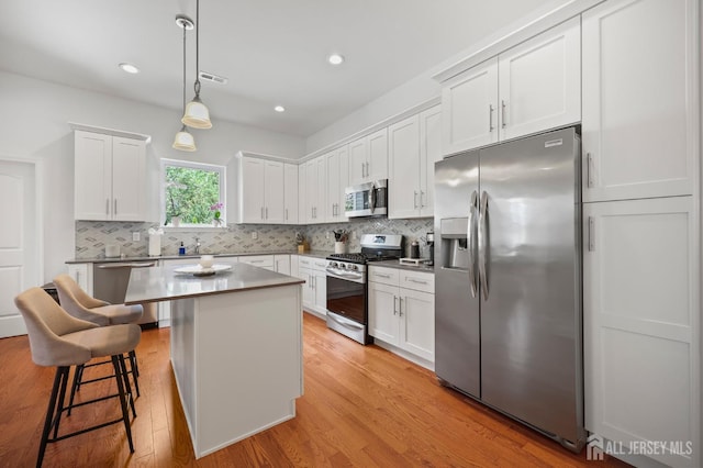 22 Sadowski Dr, Old Bridge, NJ 08857 - kitchen featuring appliances with stainless steel finishes, light wood-type flooring, white cabinetry, and recessed lighting