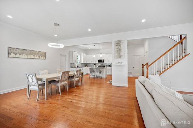 22 Sadowski Dr, Old Bridge, NJ 08857 - dining space featuring light wood-style floors, recessed lighting, crown molding, and stairway