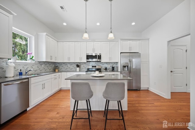 22 Sadowski Dr, Old Bridge, NJ 08857 - kitchen featuring stainless steel appliances, white cabinetry, backsplash, a kitchen island, and recessed lighting