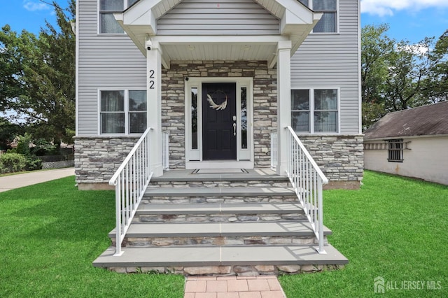 22 Sadowski Dr, Old Bridge, NJ 08857 - view of exterior entry featuring stone siding and a yard