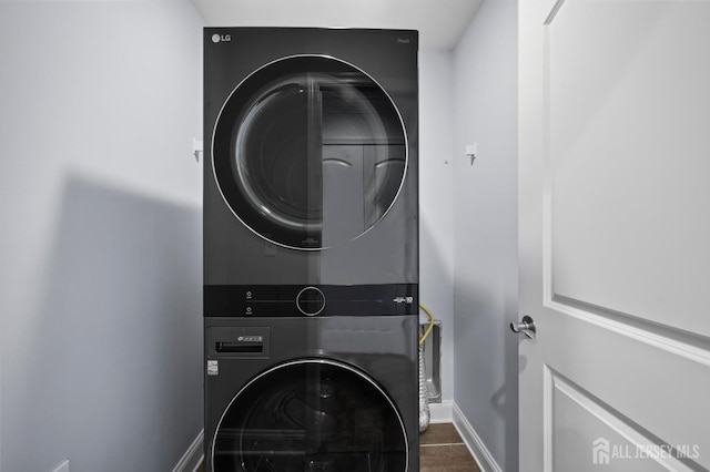 22 Sadowski Dr, Old Bridge, NJ 08857 - laundry area featuring stacked washer / dryer and wood finished floors