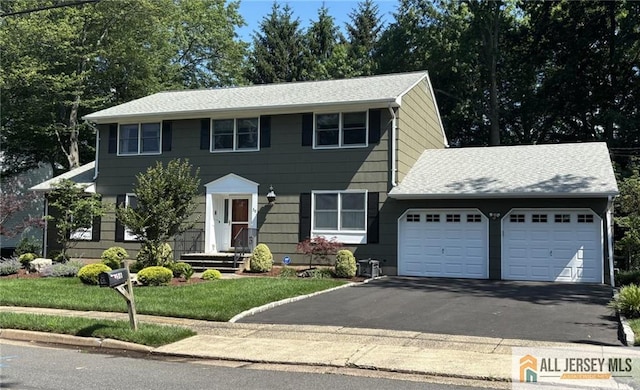 56 Monroe Ave, Edison, NJ 08820 - colonial-style house featuring a garage, driveway, and a front lawn