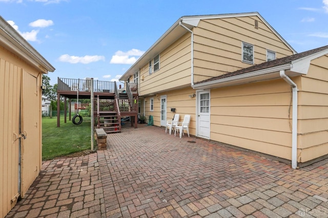 view of home's exterior with a lawn, a patio area, and a wooden deck