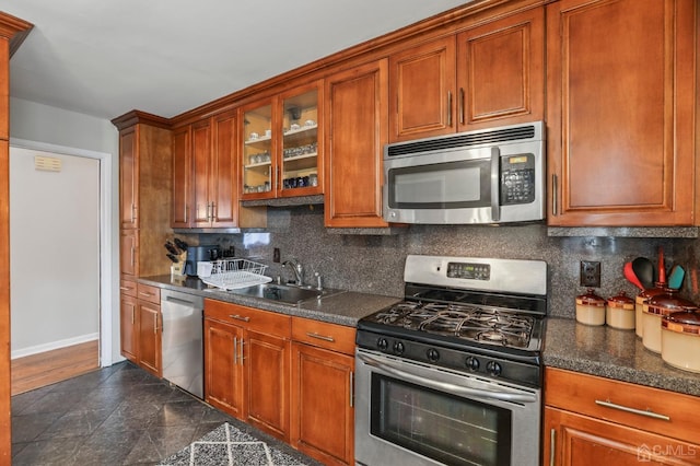 kitchen with appliances with stainless steel finishes, backsplash, and sink