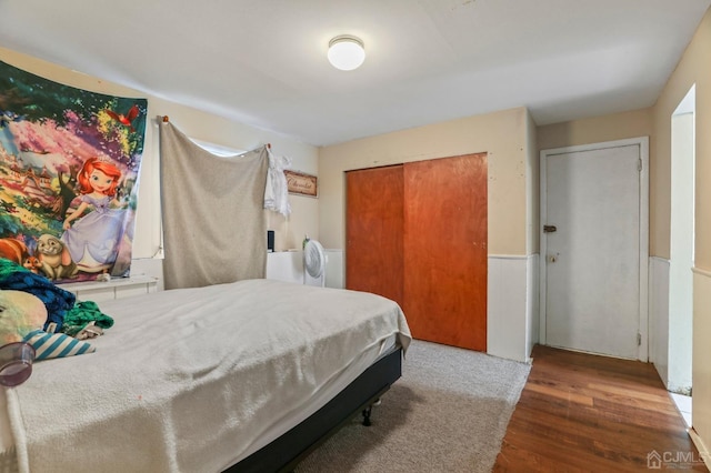 bedroom with dark hardwood / wood-style flooring