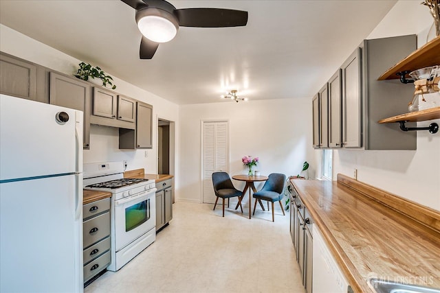 414 Graham St, Highland Park, NJ 08904 - kitchen featuring white appliances, butcher block counters, open shelves, light floors, and ceiling fan