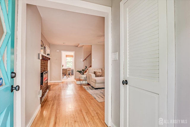 414 Graham St, Highland Park, NJ 08904 - entrance foyer featuring a fireplace, light wood finished floors, and stairs