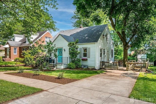 414 Graham St, Highland Park, NJ 08904 - new england style home featuring roof with shingles, driveway, and a gate