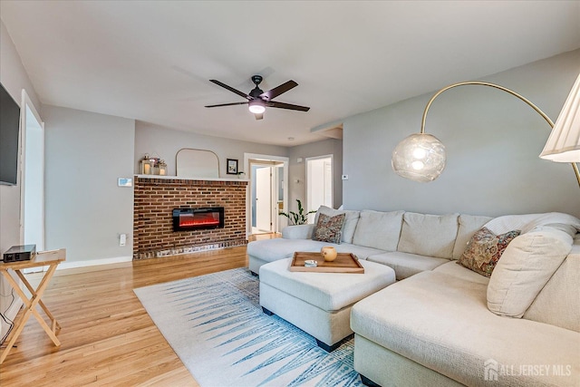 414 Graham St, Highland Park, NJ 08904 - living area featuring wood finished floors, a ceiling fan, and a fireplace