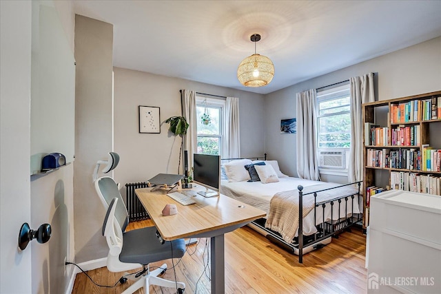414 Graham St, Highland Park, NJ 08904 - bedroom with multiple windows, radiator heating unit, light wood-type flooring, and cooling unit