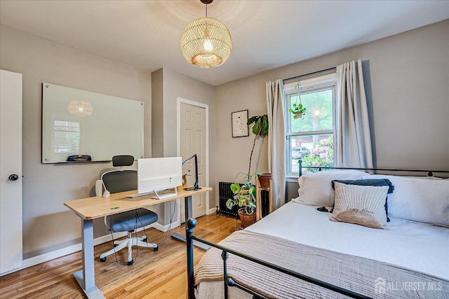 414 Graham St, Highland Park, NJ 08904 - bedroom featuring a chandelier, a desk, and light wood-style flooring