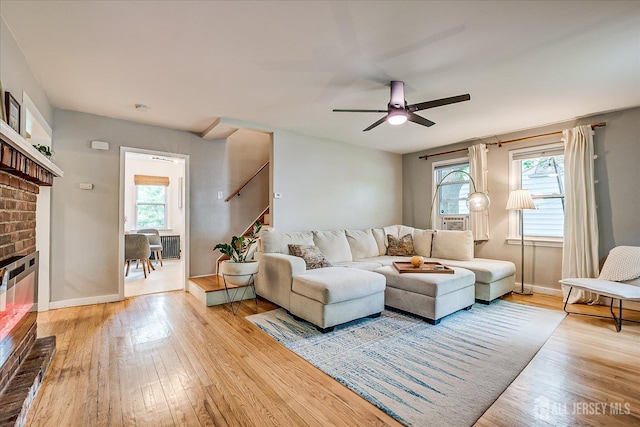 414 Graham St, Highland Park, NJ 08904 - living room with a fireplace, light wood-style flooring, and healthy amount of natural light
