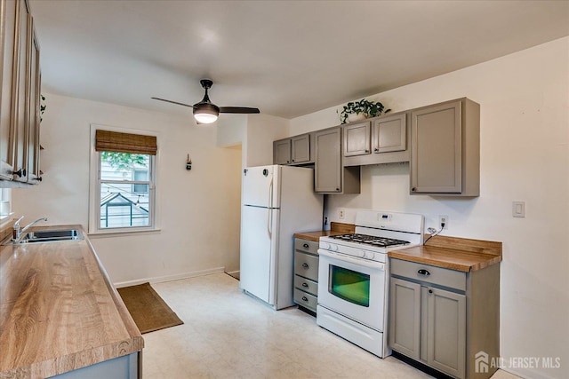 414 Graham St, Highland Park, NJ 08904 - kitchen with white appliances, gray cabinets, light floors, ceiling fan, and butcher block counters