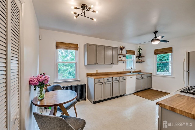 414 Graham St, Highland Park, NJ 08904 - kitchen featuring white appliances, radiator, gray cabinets, a ceiling fan, and a chandelier