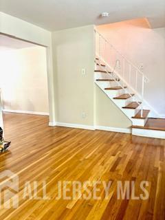 318 High St, Perth Amboy, NJ 08861 - unfurnished living room featuring wood finished floors