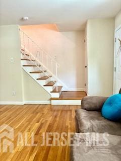318 High St, Perth Amboy, NJ 08861 - living area featuring stairway and wood finished floors