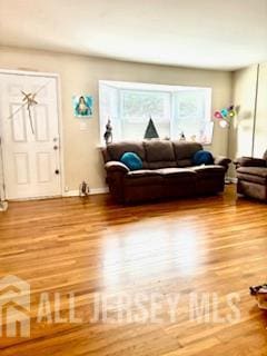 318 High St, Perth Amboy, NJ 08861 - living room featuring wood finished floors and plenty of natural light