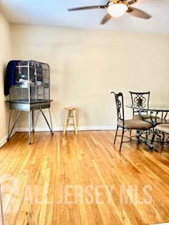 318 High St, Perth Amboy, NJ 08861 - living area featuring a ceiling fan and wood finished floors