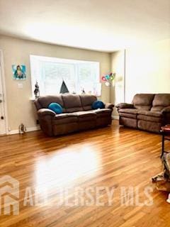 318 High St, Perth Amboy, NJ 08861 - living area with healthy amount of natural light and light wood-type flooring