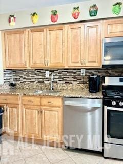 318 High St, Perth Amboy, NJ 08861 - kitchen featuring appliances with stainless steel finishes, backsplash, light brown cabinetry, light stone countertops, and light tile patterned floors