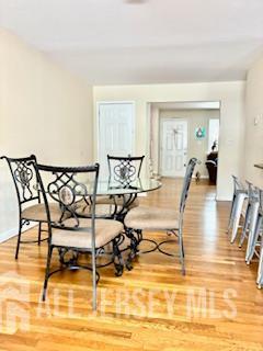 318 High St, Perth Amboy, NJ 08861 - dining room featuring light wood-style flooring and baseboards