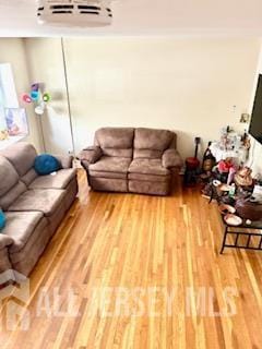 318 High St, Perth Amboy, NJ 08861 - living room featuring wood finished floors and a wall mounted air conditioner