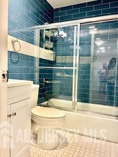 318 High St, Perth Amboy, NJ 08861 - full bathroom with bath / shower combo with glass door and tile walls