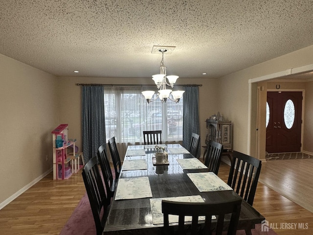 741 S Middlesex Ave S, Colonia, NJ 07067 - dining space with a chandelier, wood finished floors, a textured ceiling, and baseboards