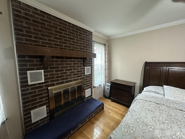 741 S Middlesex Ave S, Colonia, NJ 07067 - bedroom featuring light wood-style flooring, crown molding, and a brick fireplace