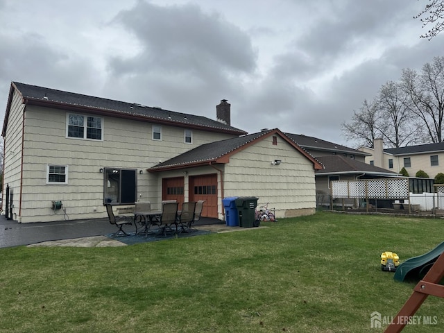 741 S Middlesex Ave S, Colonia, NJ 07067 - back of property with a patio, a chimney, and a garage