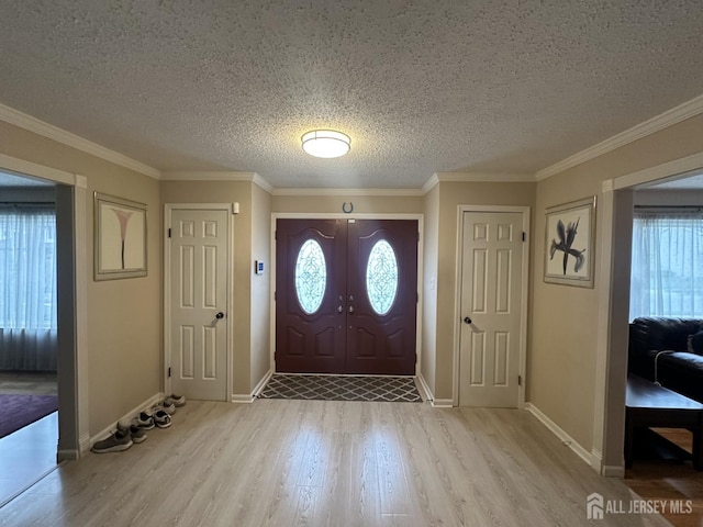 741 S Middlesex Ave S, Colonia, NJ 07067 - entrance foyer with light wood-style floors, baseboards, a textured ceiling, and ornamental molding