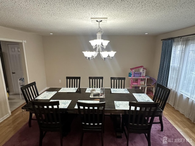 741 S Middlesex Ave S, Colonia, NJ 07067 - dining area with wood finished floors, a chandelier, and a textured ceiling