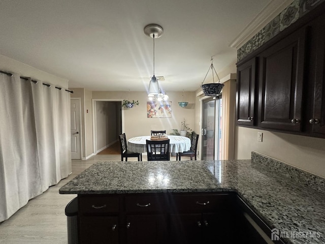 741 S Middlesex Ave S, Colonia, NJ 07067 - kitchen with a peninsula, dark cabinetry, stone counters, and light wood-style floors