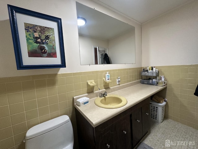 741 S Middlesex Ave S, Colonia, NJ 07067 - bathroom featuring tile walls, toilet, vanity, and a wainscoted wall