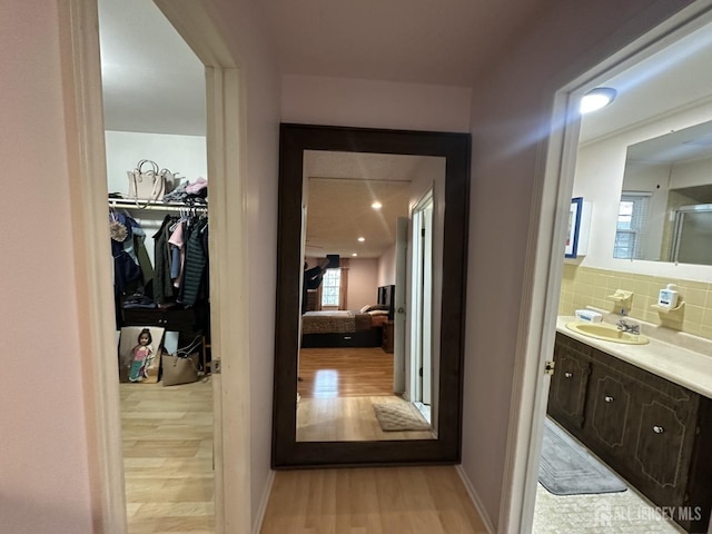 741 S Middlesex Ave S, Colonia, NJ 07067 - corridor featuring a sink, light wood-style flooring, and healthy amount of natural light