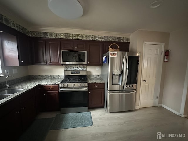 741 S Middlesex Ave S, Colonia, NJ 07067 - kitchen with appliances with stainless steel finishes, a sink, light wood finished floors, ornamental molding, and dark brown cabinets