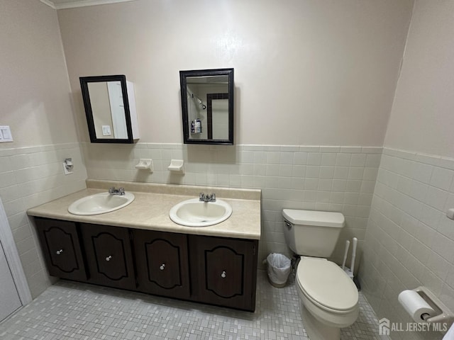 741 S Middlesex Ave S, Colonia, NJ 07067 - full bath featuring tile walls, double vanity, a wainscoted wall, tile patterned floors, and toilet