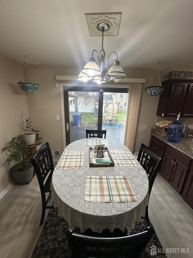 741 S Middlesex Ave S, Colonia, NJ 07067 - dining area featuring light wood-style floors, a chandelier, and baseboards
