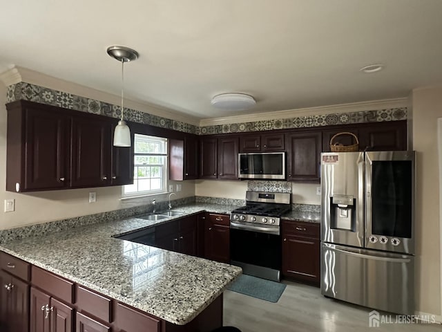 741 S Middlesex Ave S, Colonia, NJ 07067 - kitchen featuring stainless steel appliances, a sink, a peninsula, decorative light fixtures, and light stone countertops