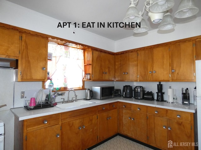 123 Heald St, Carteret, NJ 07008 - kitchen with stainless steel microwave, brown cabinetry, and light countertops