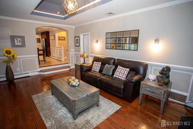 1 Stradford Rd, Sayreville, NJ 08859 - living area featuring arched walkways, wood finished floors, crown molding, a decorative wall, and a raised ceiling