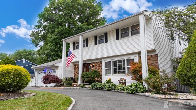 1 Stradford Rd, Sayreville, NJ 08859 - view of front of home with an attached garage and stone siding