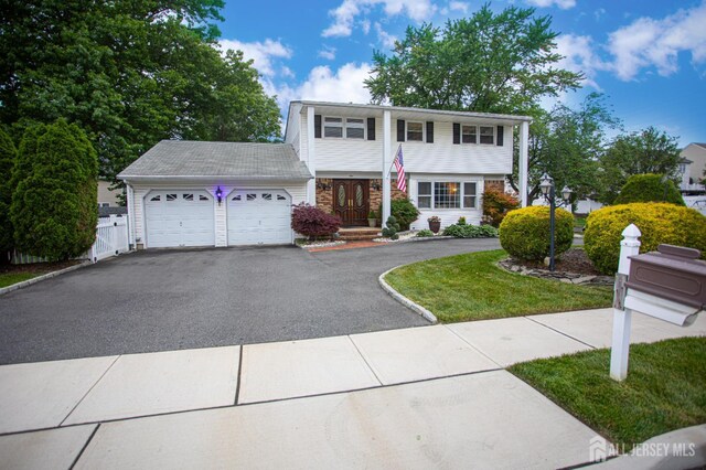 1 Stradford Rd, Sayreville, NJ 08859 - colonial home featuring asphalt driveway, an attached garage, and a front lawn